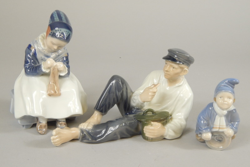 Appraisal: Three items of Royal Copenhagen porcelain a recumbent man holding