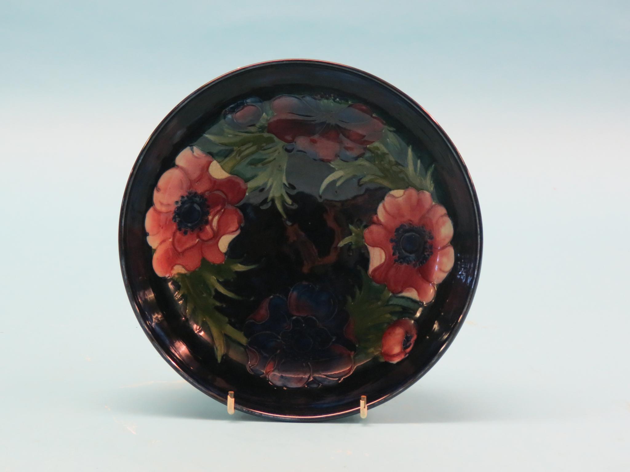 Appraisal: A Moorcroft bowl painted with stylised plants against a deep