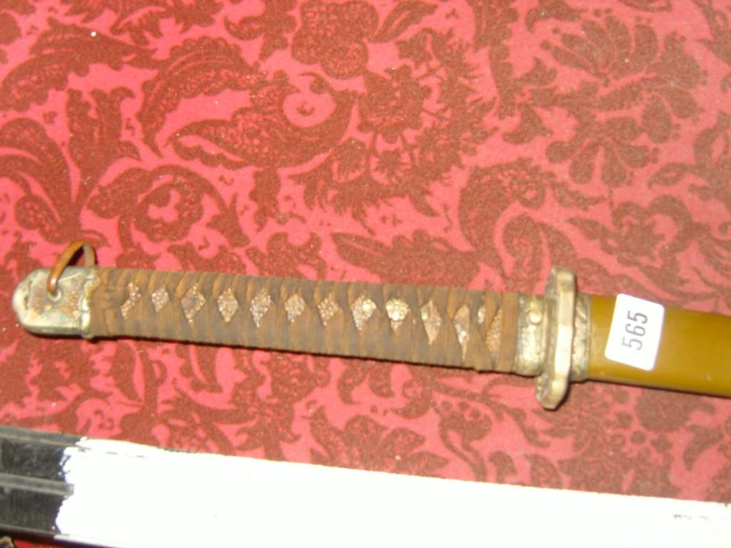 Appraisal: A WWII Japanese sword with steel scabbard with laced grip