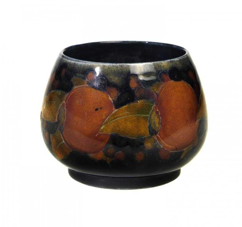 Appraisal: A MOORCROFT POMEGRANATE SUGAR BOWL DESIGNED BY WILLIAM MOORCROFT cm