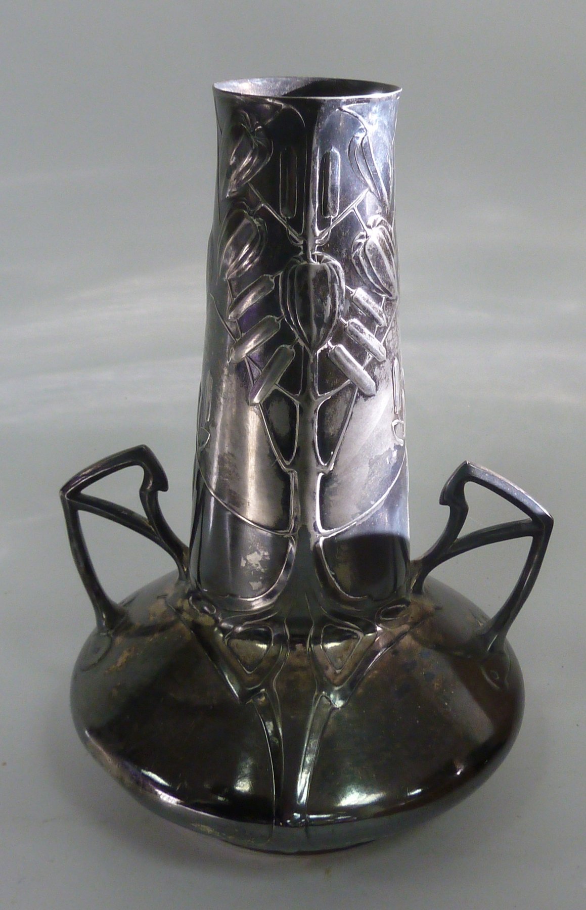 Appraisal: An Art Nouveau pewter vase the tapering cylindrical neck decorated