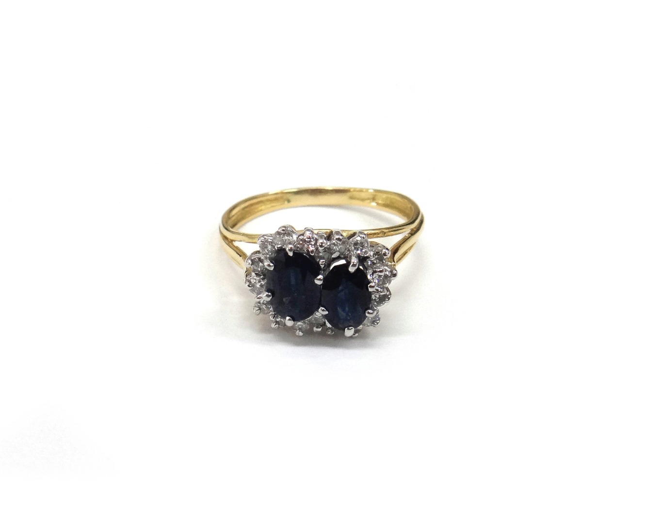 Appraisal: A sapphire and diamond double cluster ring on a three