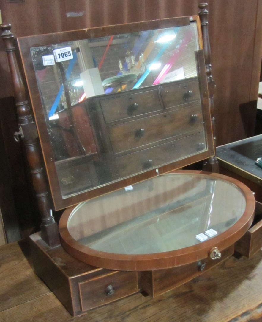 Appraisal: A th century mahogany toilet mirror with three drawer base