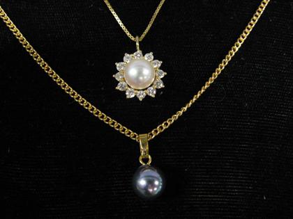 Appraisal: Two pearl pendants karat yellow gold neckchains each set with