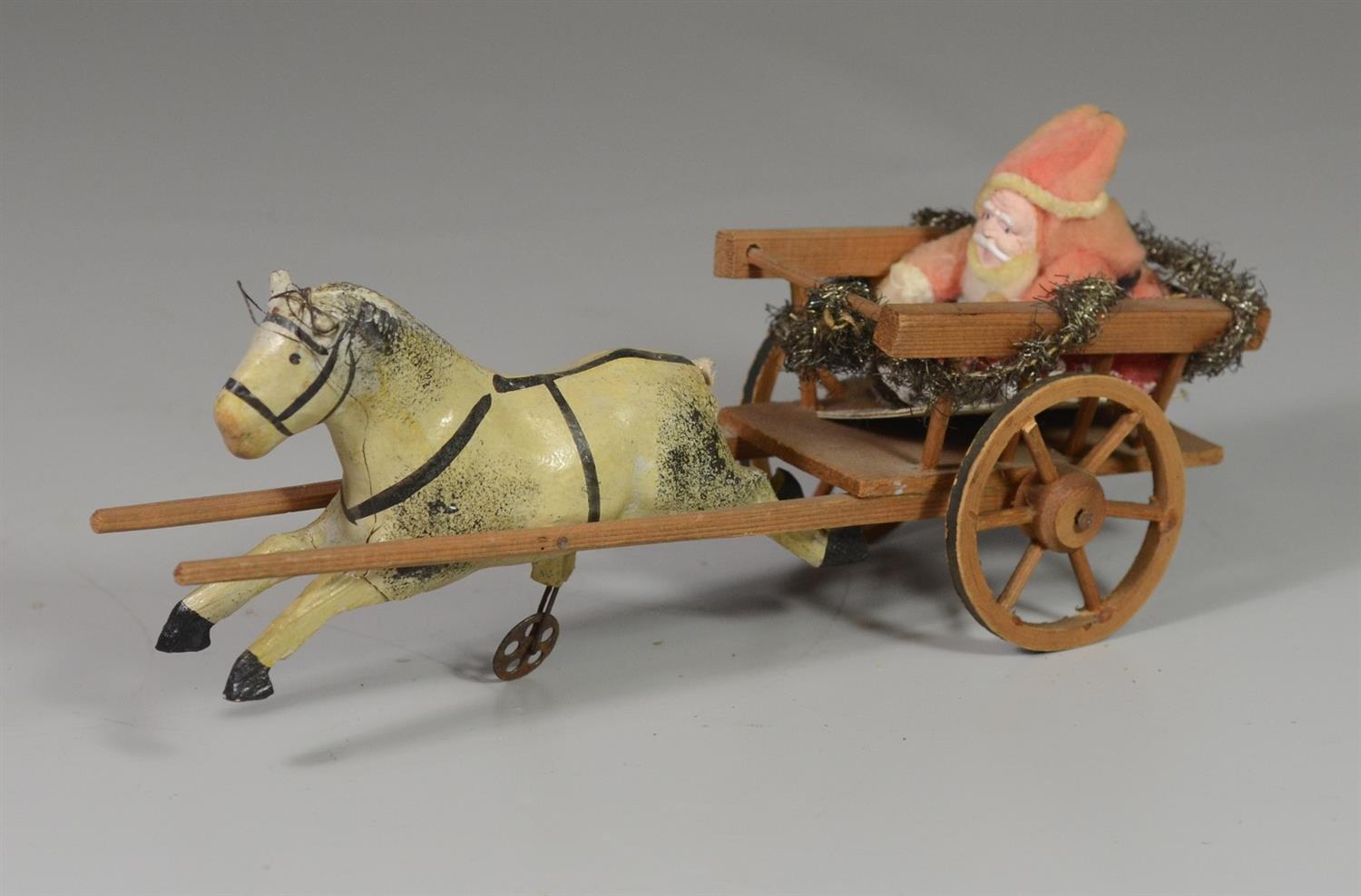 Appraisal: Cotton celluloid Santa in wooden cart with horse tail missing