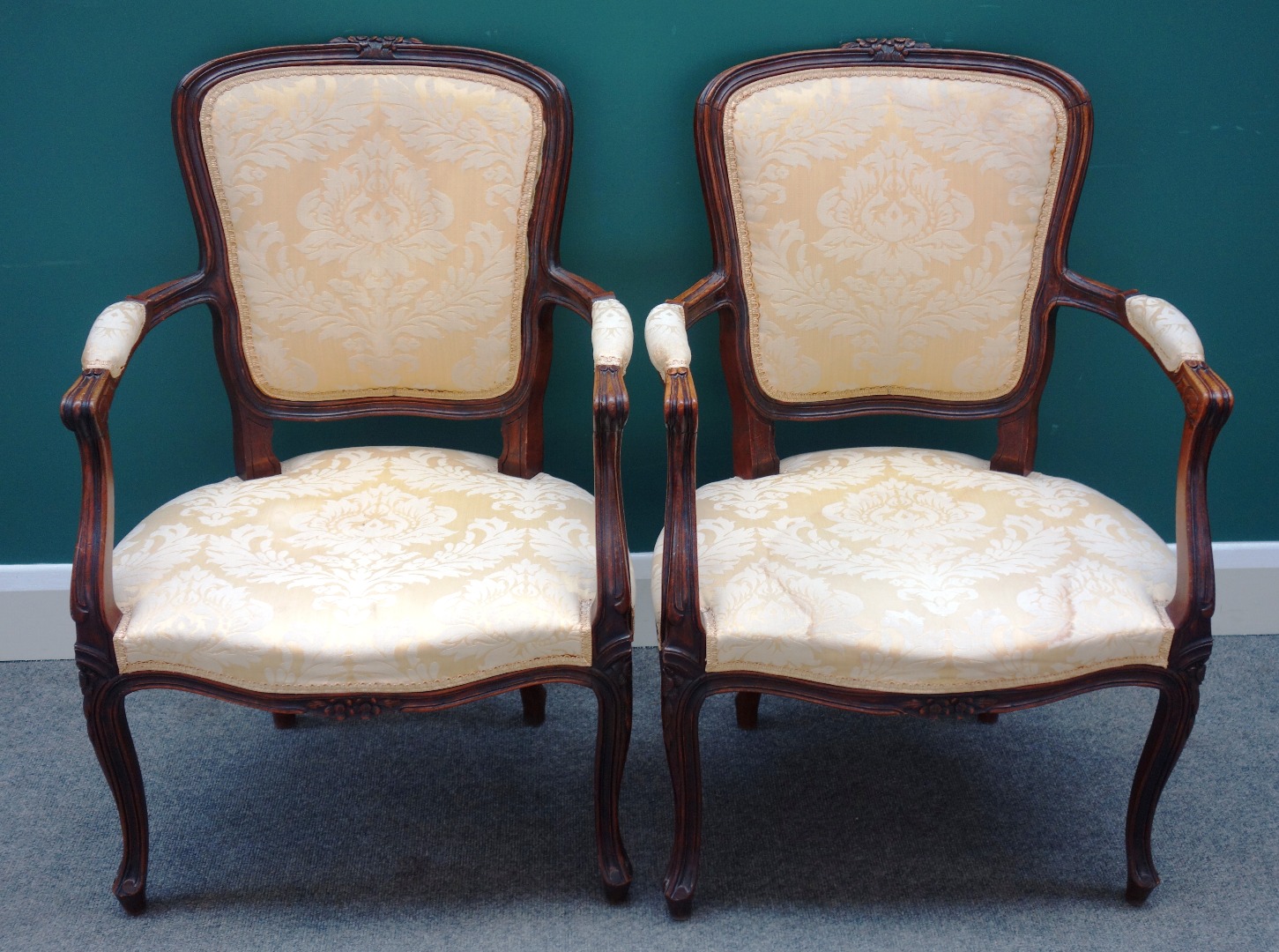 Appraisal: A pair of Louis XV style stained beech fauteuils on