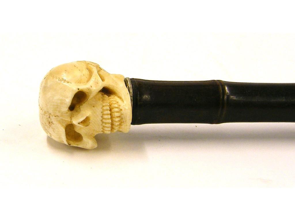 Appraisal: Bamboo walking cane with carved ivory skull finial