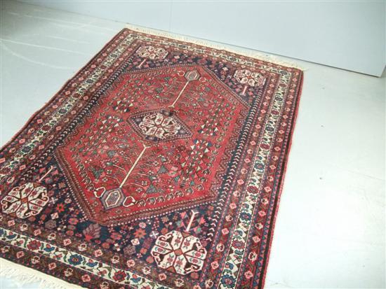 Appraisal: Persian red ground rug with various borders and central stepped