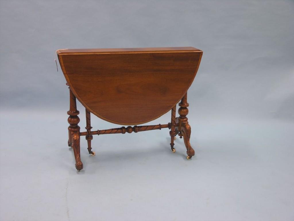 Appraisal: A Victorian mahogany Sutherland table on turned end supports with