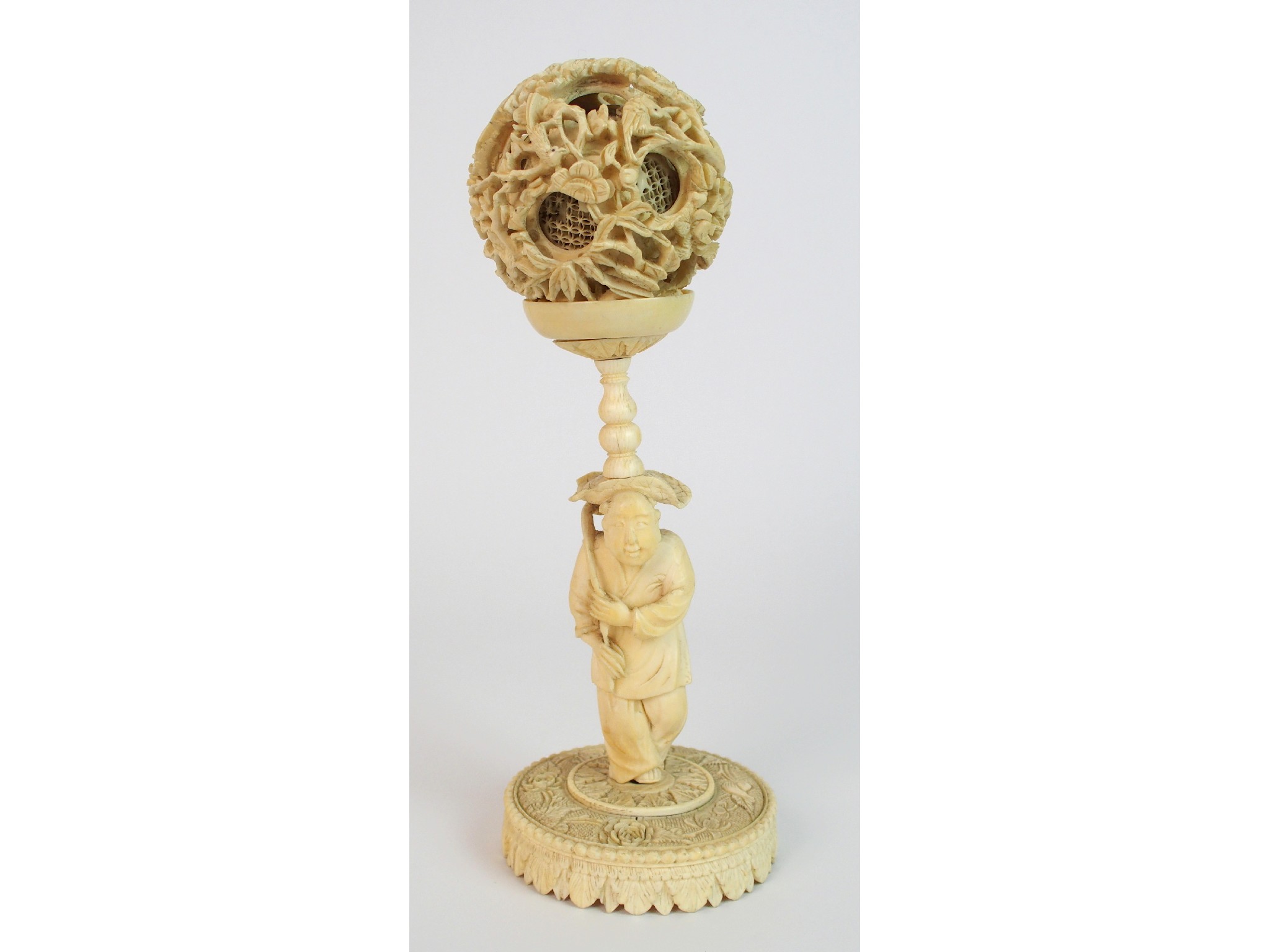 Appraisal: A Chinese carved ivory concentric ball and standcarved with a