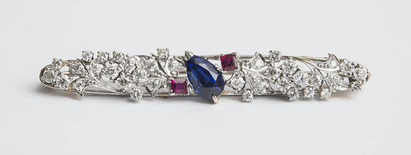 Appraisal: PLATINUM DIAMOND SAPPHIRE AND RUBY BAR PIN Openwork floral design