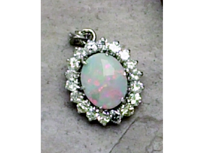 Appraisal: OPAL AND DIAMOND PENDANT White gold oval design pendant with