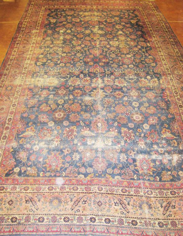 Appraisal: A bordered Persian Carpet with palmette design on a blue