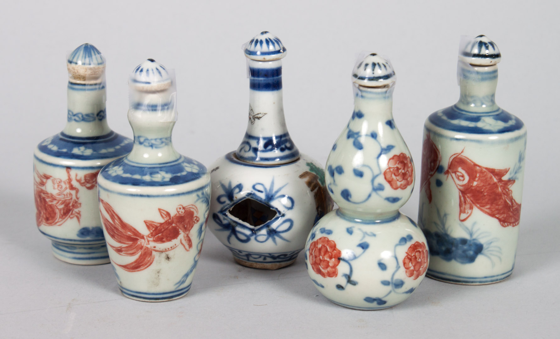 Appraisal: Five Chinese porcelain snuff bottles one with Famille Rose court