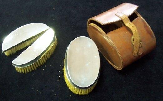 Appraisal: A set of three silver backed hairbrushes leather cased Walker