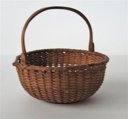 Appraisal: Nantucket basket with swing handle early th century Circular shape