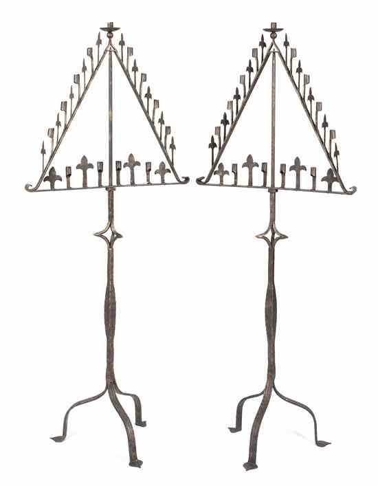 Appraisal: A Pair of Wrought Iron Prickets having a single candle