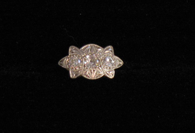 Appraisal: AN EDWARDIAN DIAMOND-SET DRESS RING the three round graduated old-cut