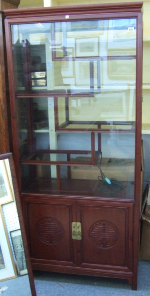 Appraisal: A th century hardwood Chinese display cabinet the glazed door