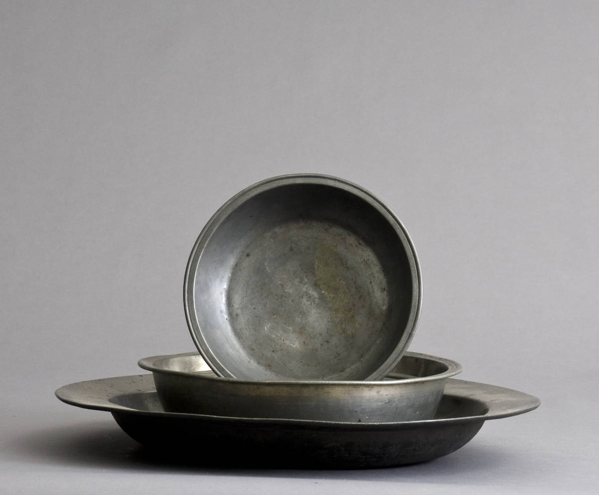 Appraisal: FOUR ENGLISH PEWTER BASINS AND A DEEP DISH CHARGER Diameter