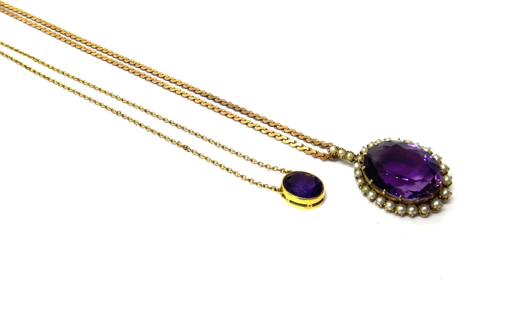 Appraisal: A gold amethyst and seed pearl set oval pendant claw