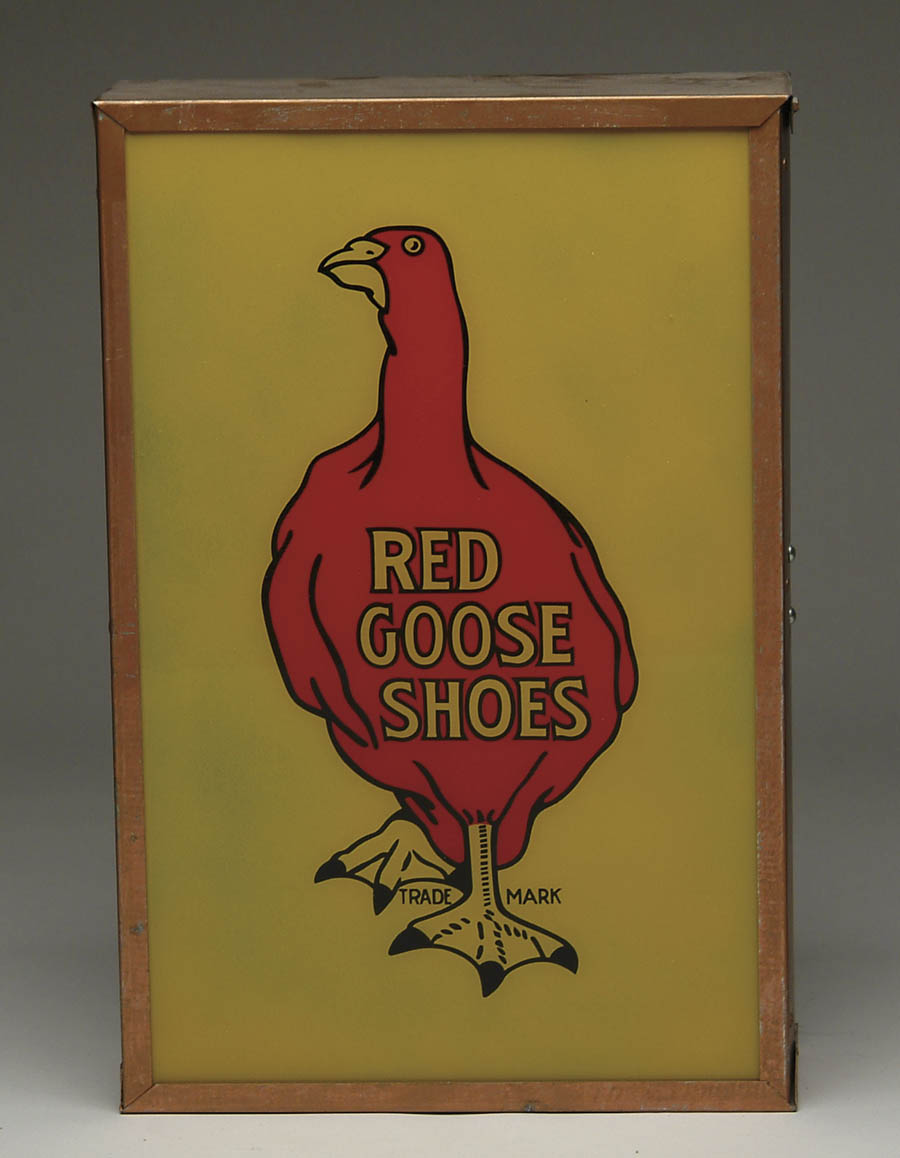 Appraisal: RED GOOSE SHOE LIGHT-UP SIGN Colorful metal framed rectangular shadowbox