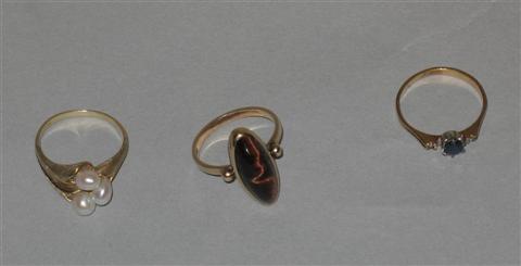 Appraisal: THREE GOLD AND PRECIOUS STONE RINGS The first set with