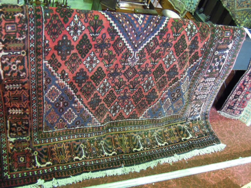 Appraisal: A Shiraz style carpet with a central lozenge stylised flowers