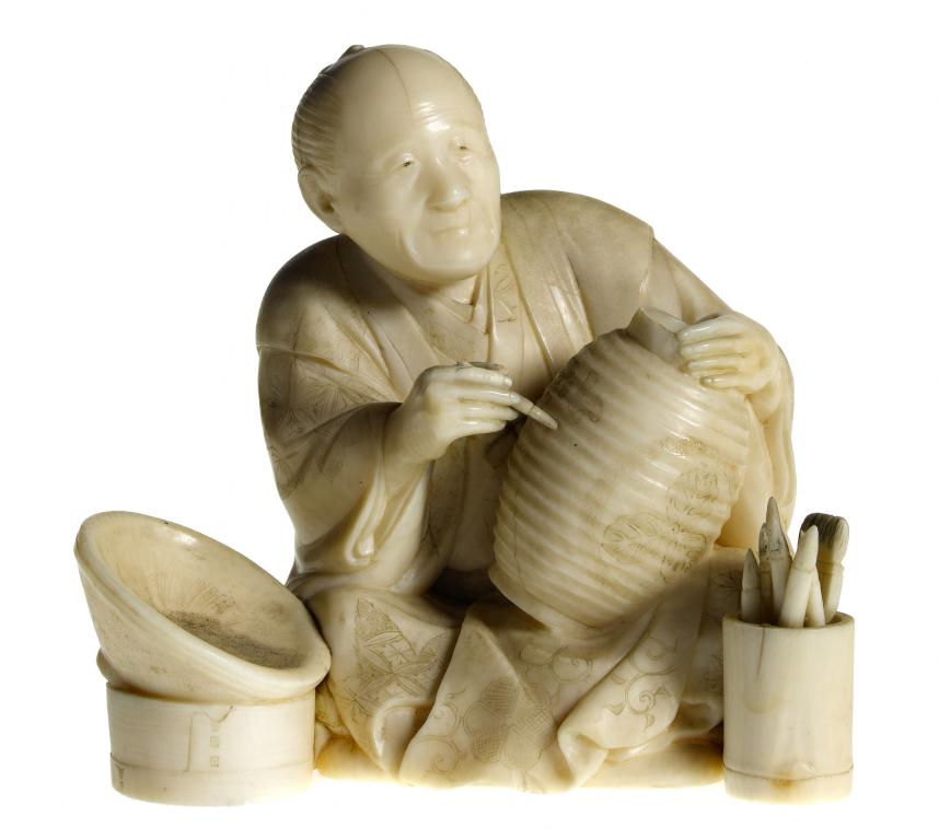 Appraisal: AN IVORY FIGURE OF A PAPER LANTERN MAKER CHOCHIN-YA seated