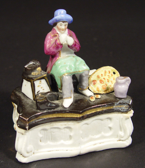 Appraisal: th century continental porcelain matchbox surmounted with a figure of