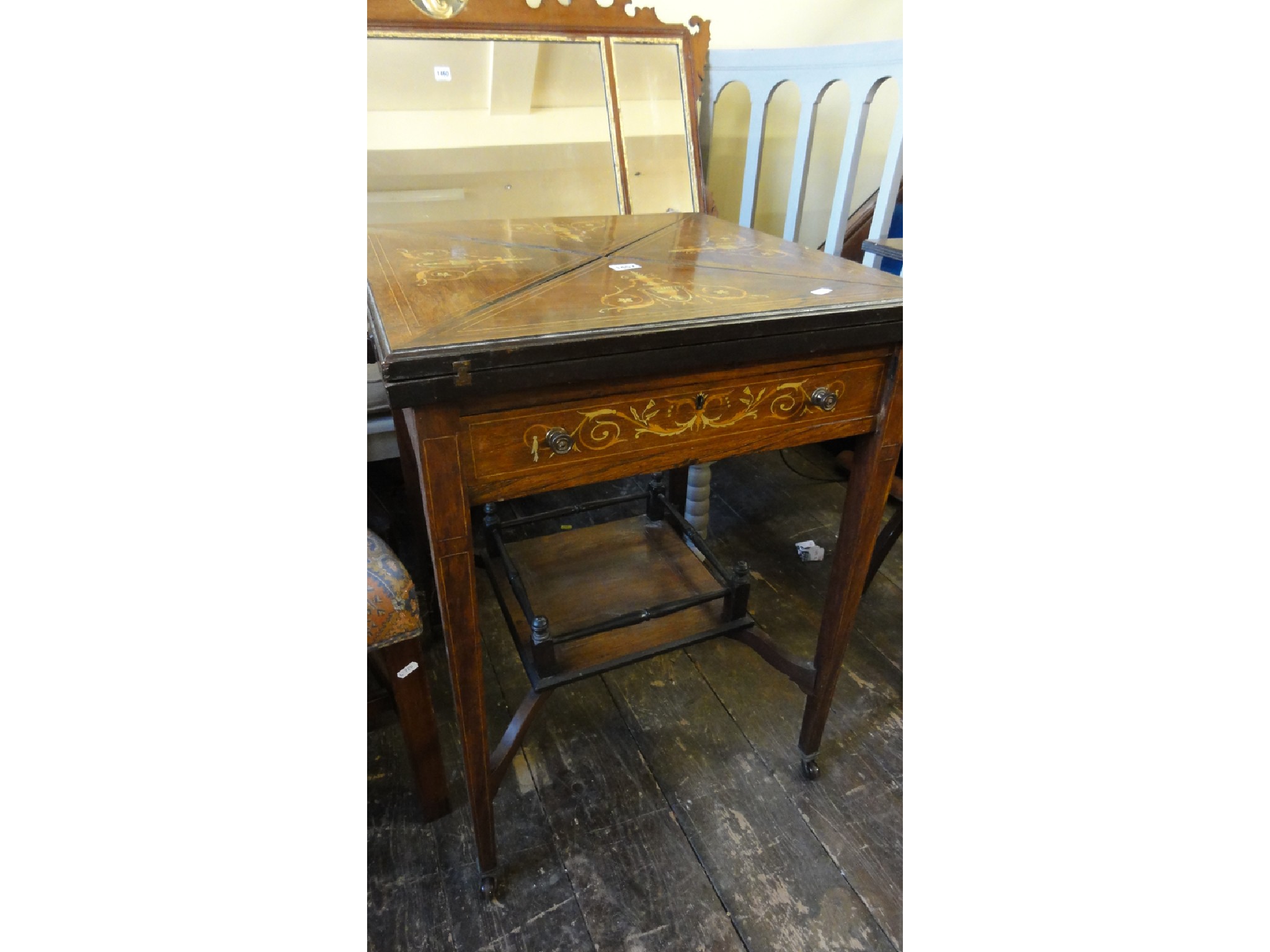 Appraisal: An inlaid Edwardian rosewood and marquetry envelope card table of