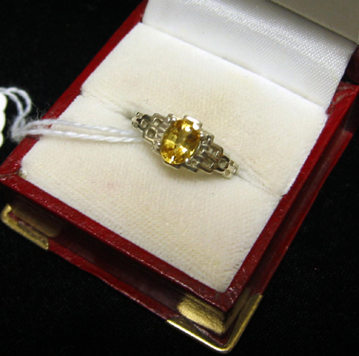 Appraisal: YELLOW SAPPHIRE AND FOURTEEN KARAT WHITE GOLD SOLITAIRE RING centering