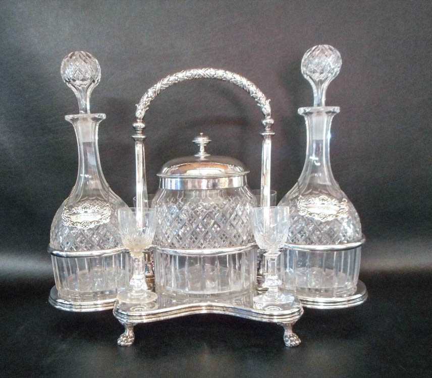 Appraisal: SILVER PLATED DECANTER AND ACCESSORIES CADDY the footed caddy with