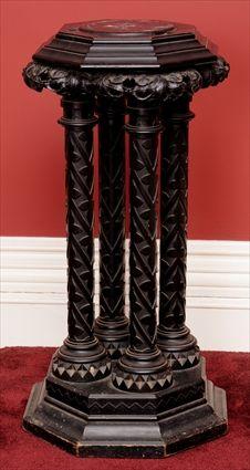 Appraisal: GOTHIC REVIVAL CARVED AND EBONIZED PEDESTAL The octagonal molded top