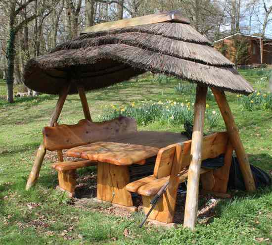 Appraisal: A naturalistic wooden garden bench set comprising two benches table