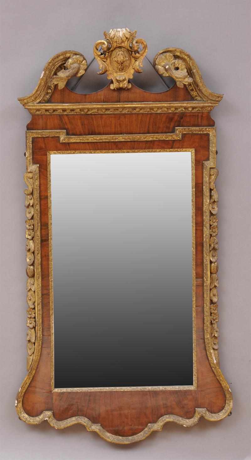 Appraisal: GEORGE II WALNUT AND CARVED GILTWOOD MIRROR The shaped frame