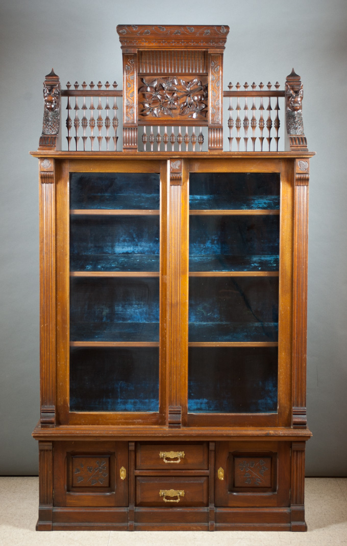 Appraisal: AN UNUSUAL VICTORIAN WALNUT CABINET BOOKCASE American th century featuring