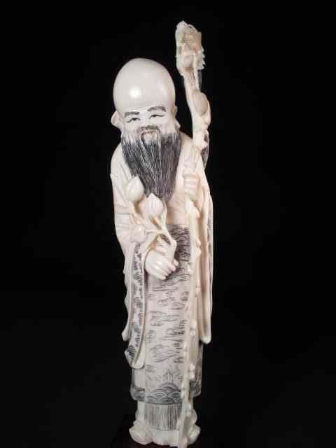 Appraisal: Chinese carved ivory figure Depicts a man with a dragon