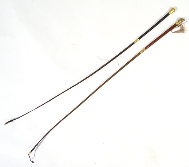 Appraisal: Two Victorian ladies leather riding crops with chased and embossed