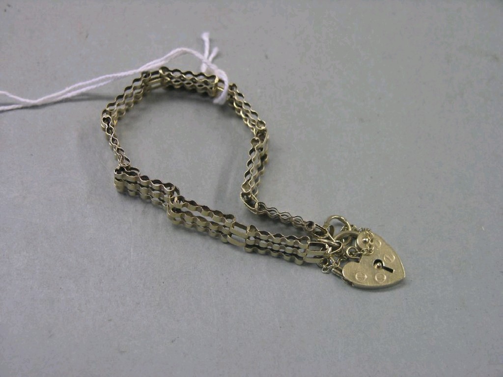 Appraisal: A ct gold link bracelet with heart-shaped padlock pendant grams