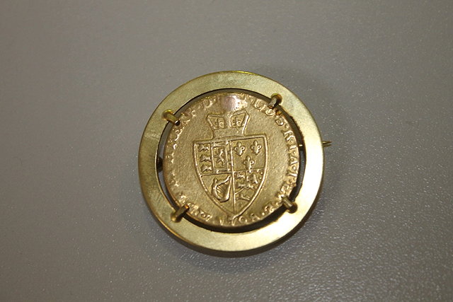 Appraisal: A BAR BROOCH of circular form mounted with a spade