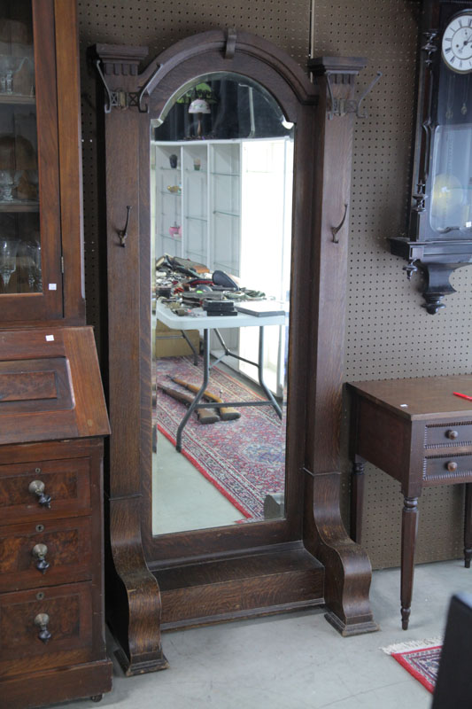 Appraisal: HALL TREE Oak having an arched mirror brass hat racks