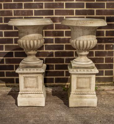 Appraisal: A pair of reconstituted stone garden vases on pedestal bases