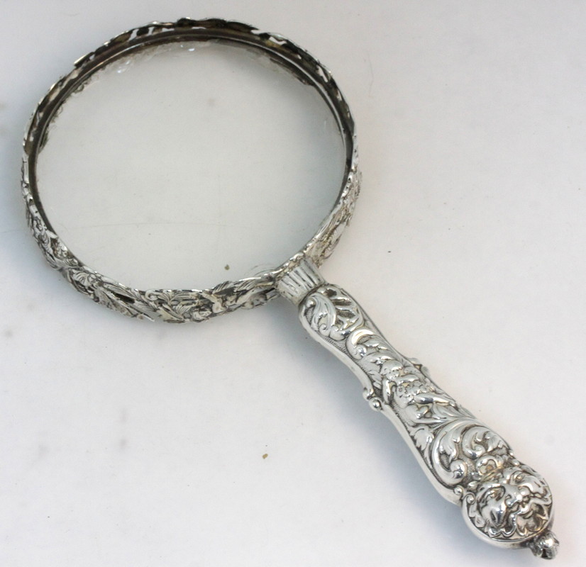 Appraisal: A magnifying glass with silver handle and frame William Comyns