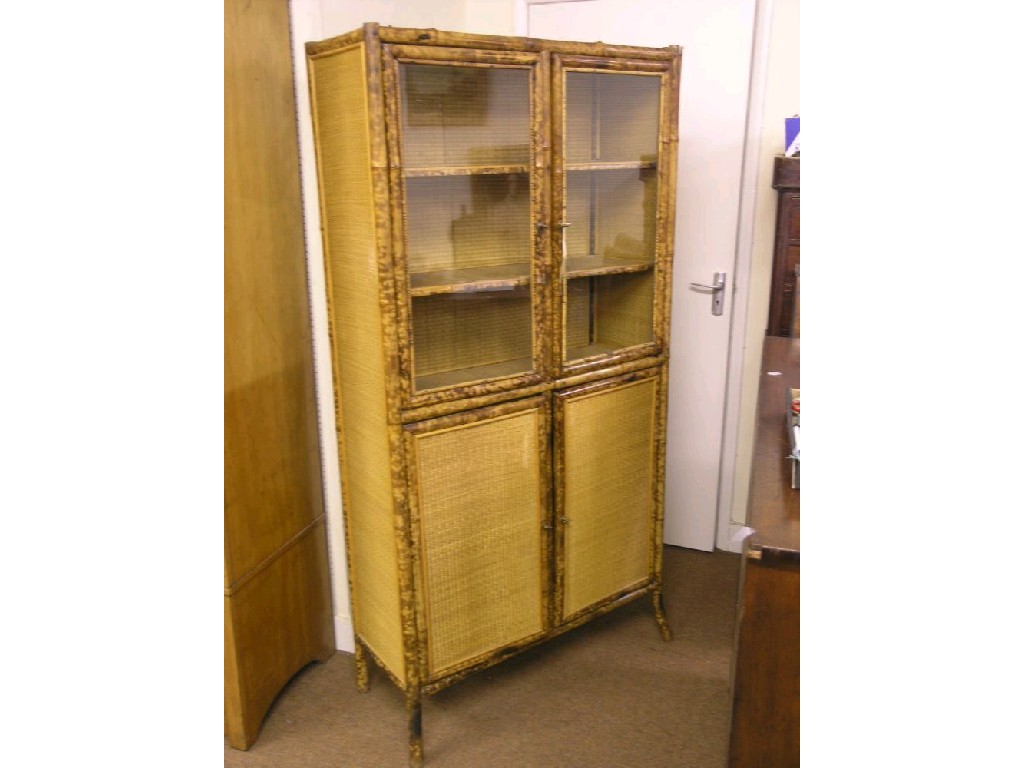 Appraisal: A Victorian bamboo display cabinet pair of glazed doors enclosing