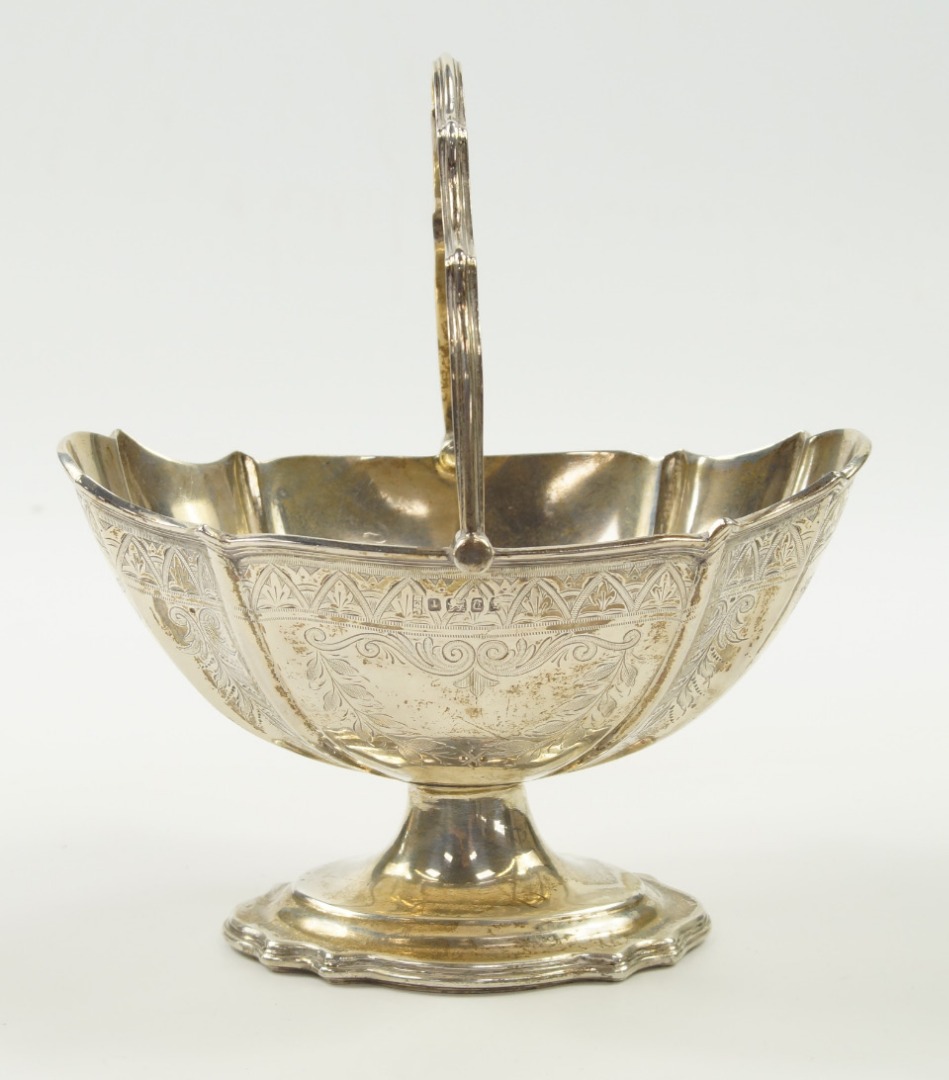 Appraisal: A Victorian silver basket of fluted oval pedestal form with