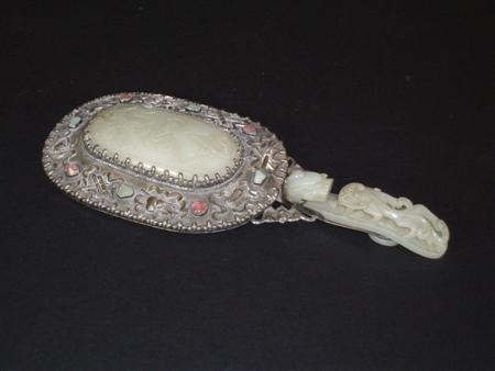 Appraisal: A Chinese white metal and jade hand mirror the reverse