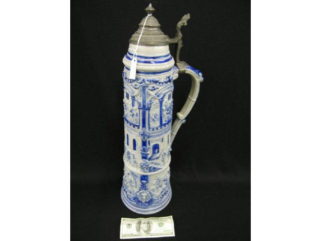 Appraisal: Huge German Pottery Stein tall ornate bas-relief scenes of knights