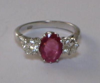 Appraisal: A RUBY AND DIAMOND THREE STONE RING the central oval