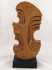 Appraisal: John Spielman An abstract mahogany sculpture on black square base